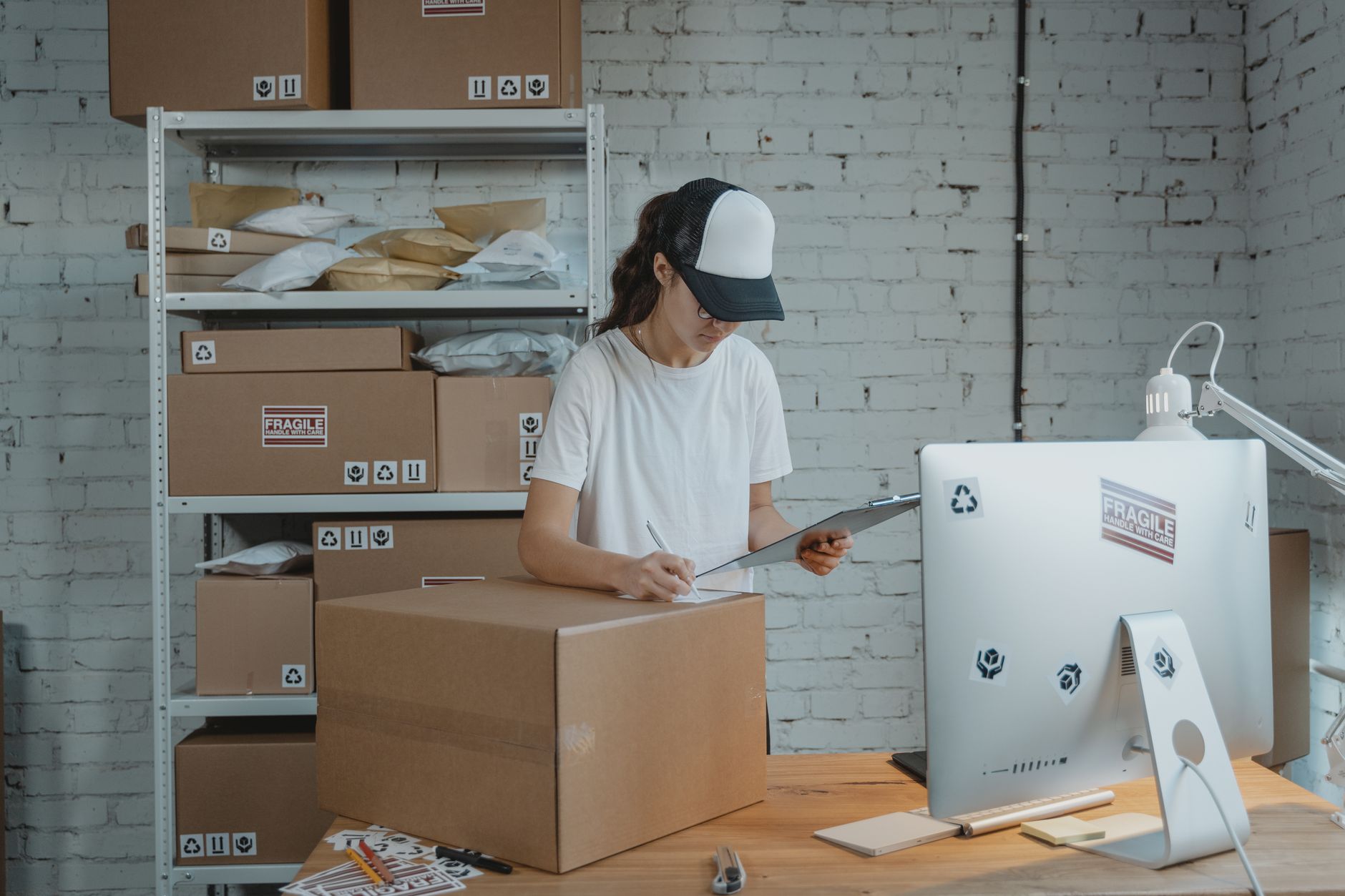 Woman managing shipping logistics for D2C small business order fulfillment