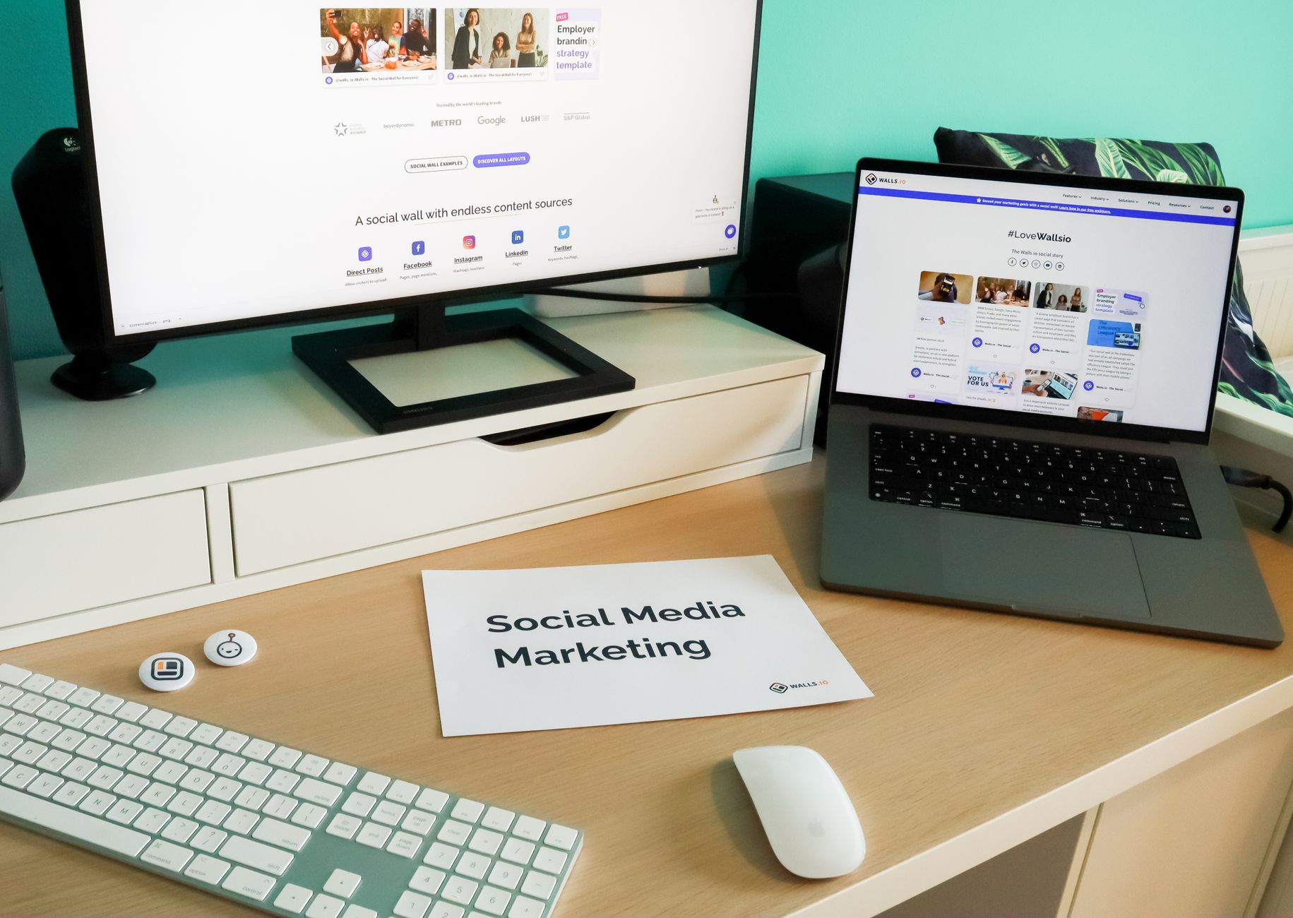 Social media marketing workspace with laptop and monitor showing social wall tools for D2C brand growth