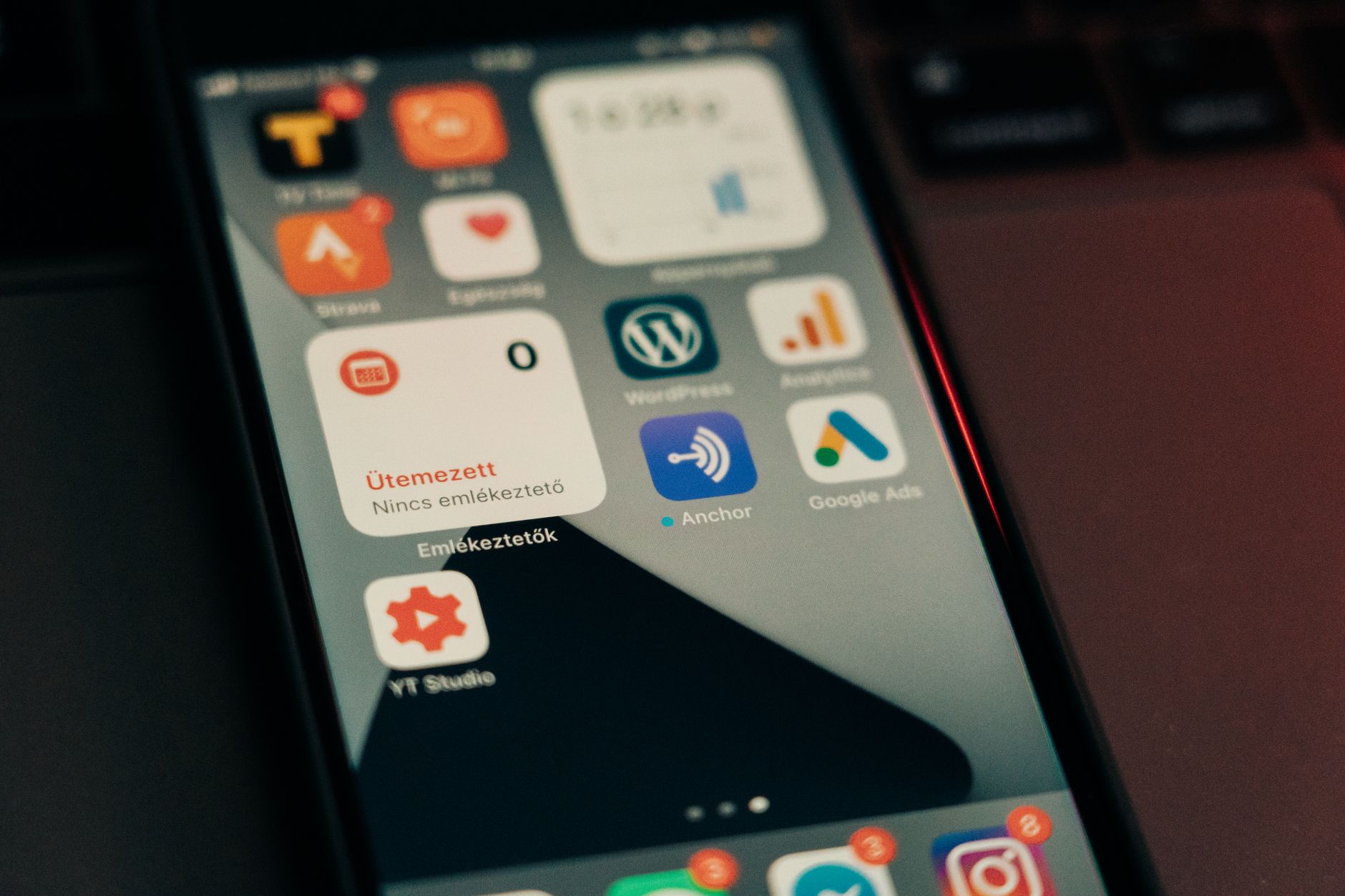 Smartphone with marketing apps Google Ads and Analytics for mobile SMS marketing campaigns