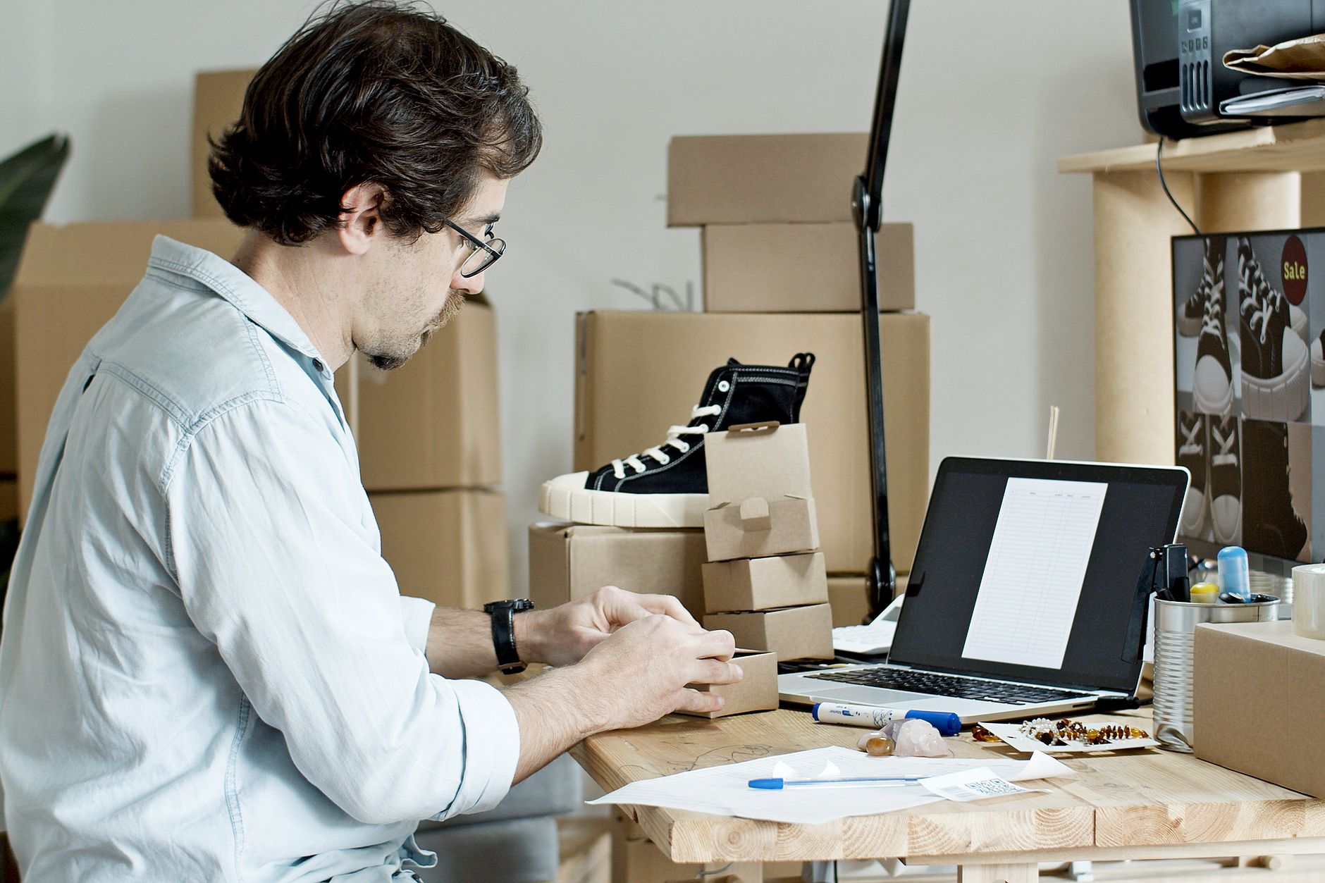 D2C brand seller managing online orders and customer reviews on laptop