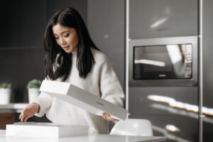 Customer unpacking a delivery box — post-purchase experience DTC brand