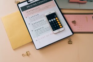 Business documents and strategy tools laid out for DTC pricing planning