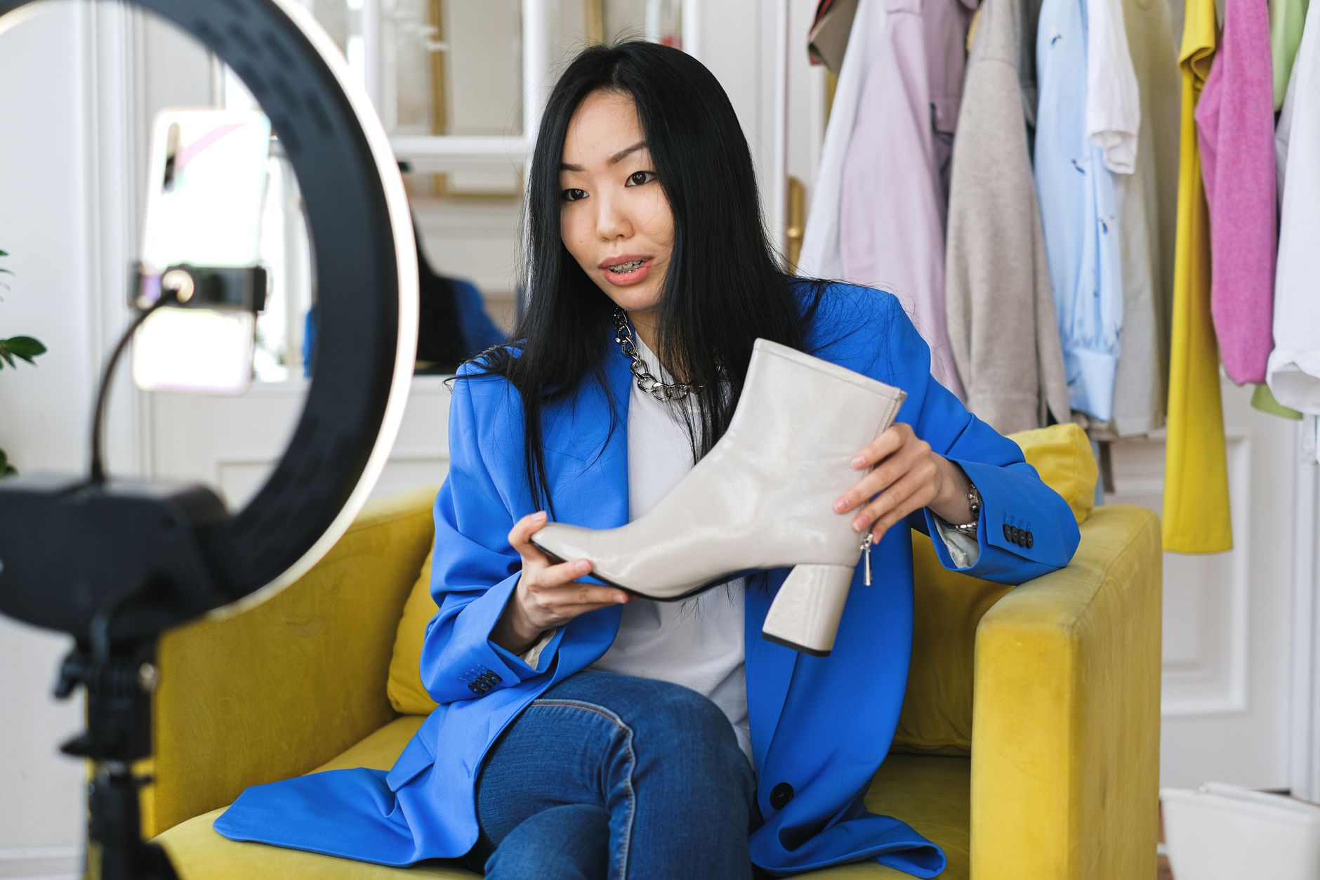 Fashion influencer reviewing product on camera with ring light for social commerce