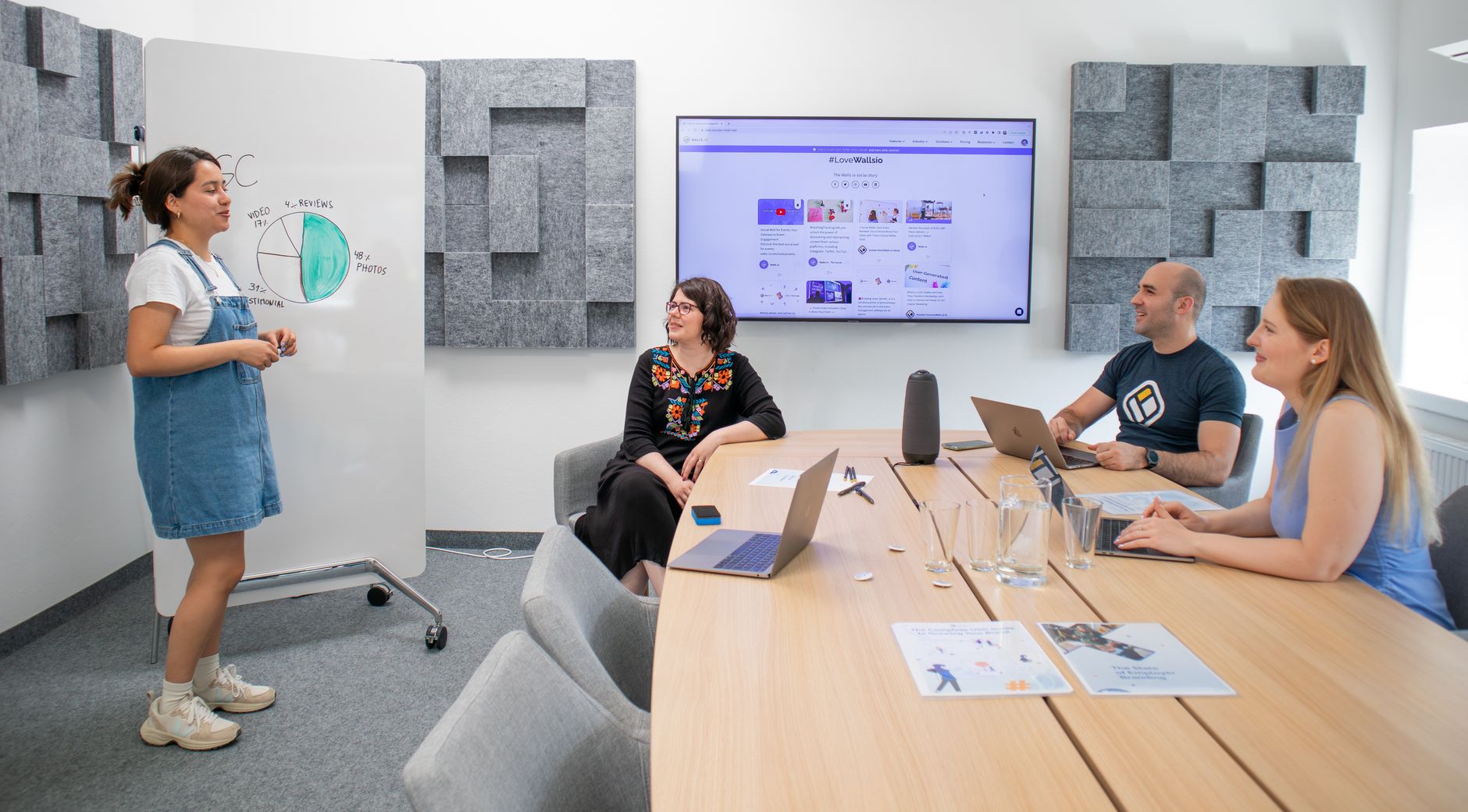 Team planning digital marketing campaign strategy around a conference table