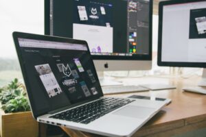 Stylish workspace with laptop and monitors for website optimization and DTC landing page CRO