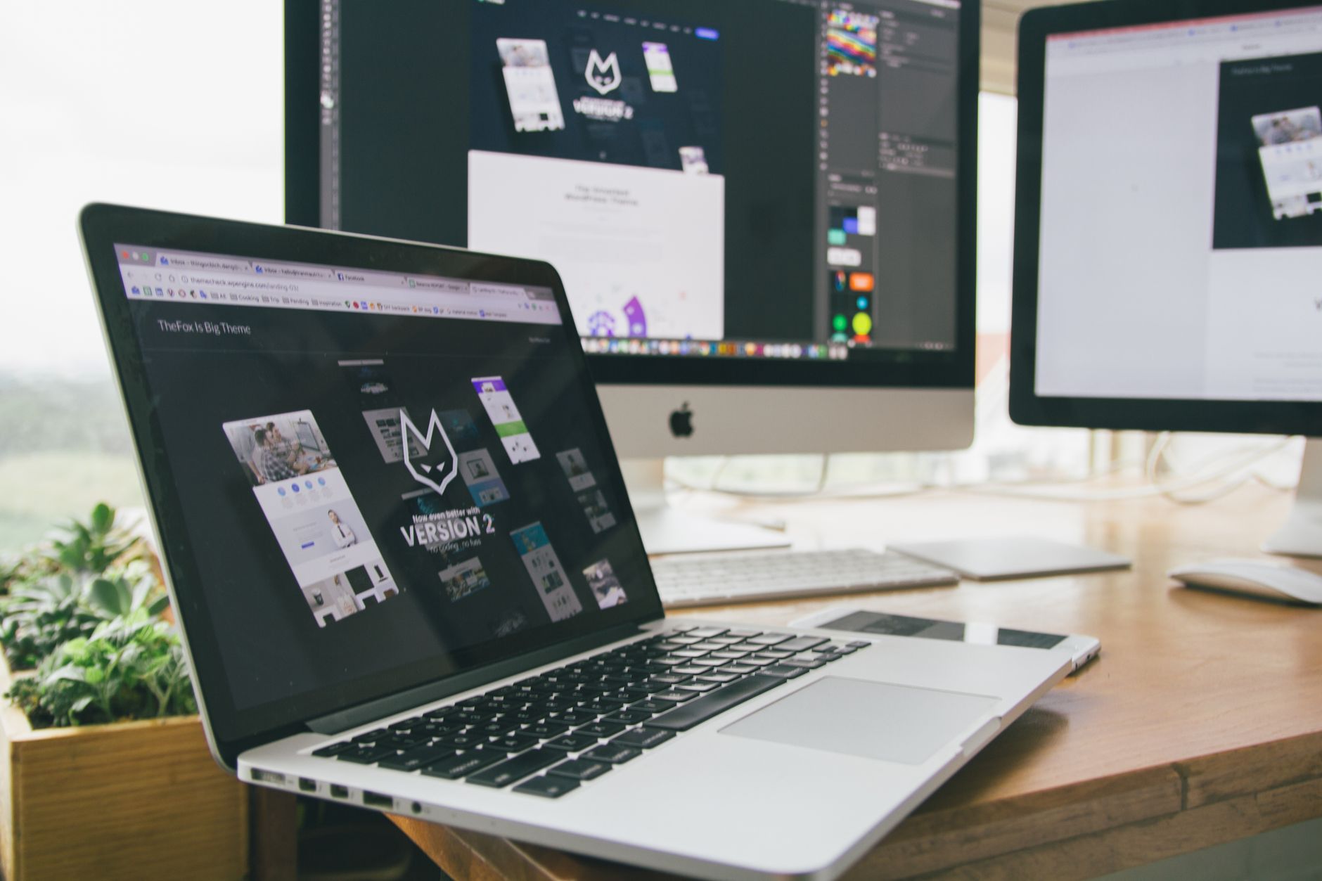 Stylish workspace with laptop and monitors for website optimization and DTC landing page CRO