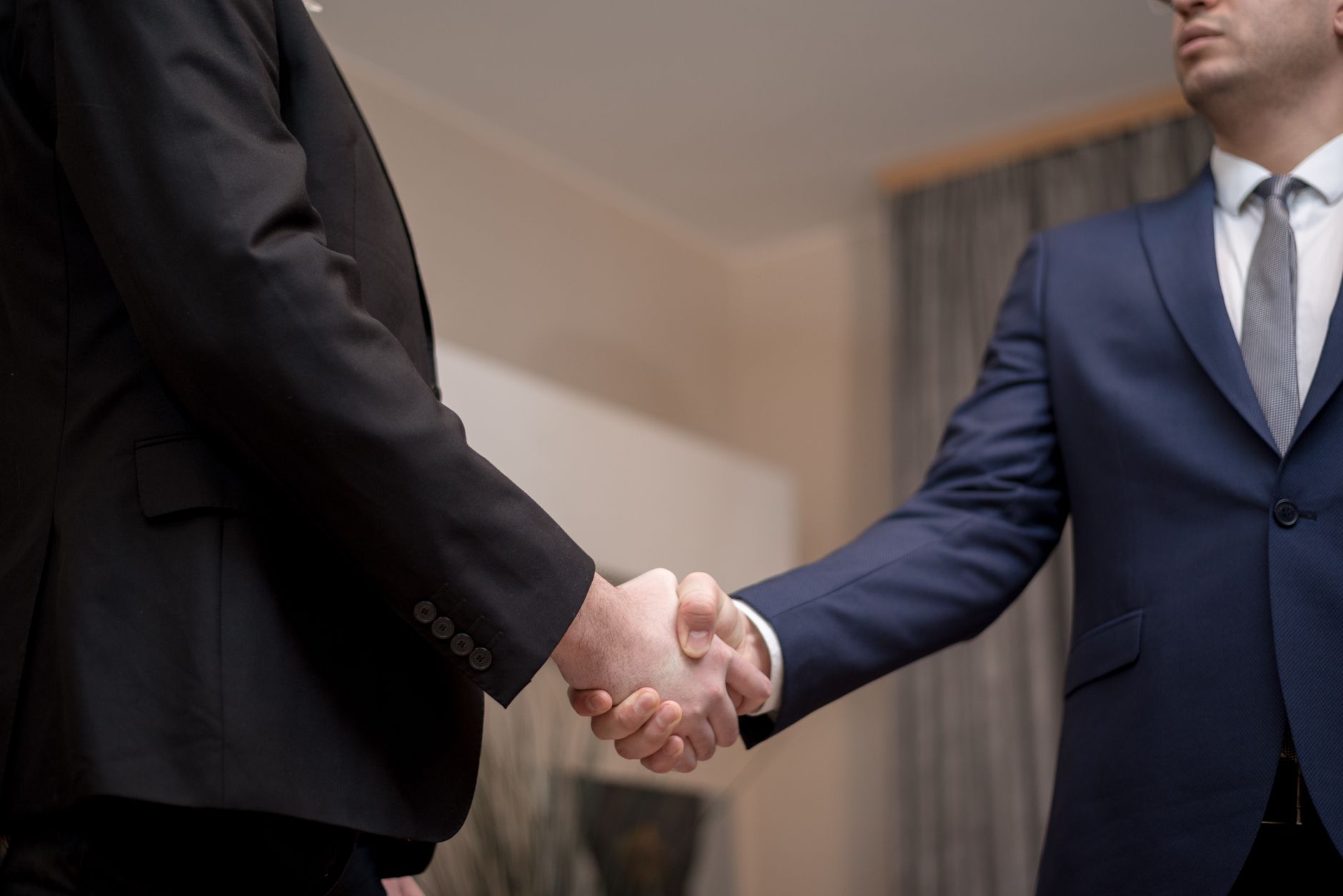 Two business professionals shaking hands representing affiliate marketing partnership