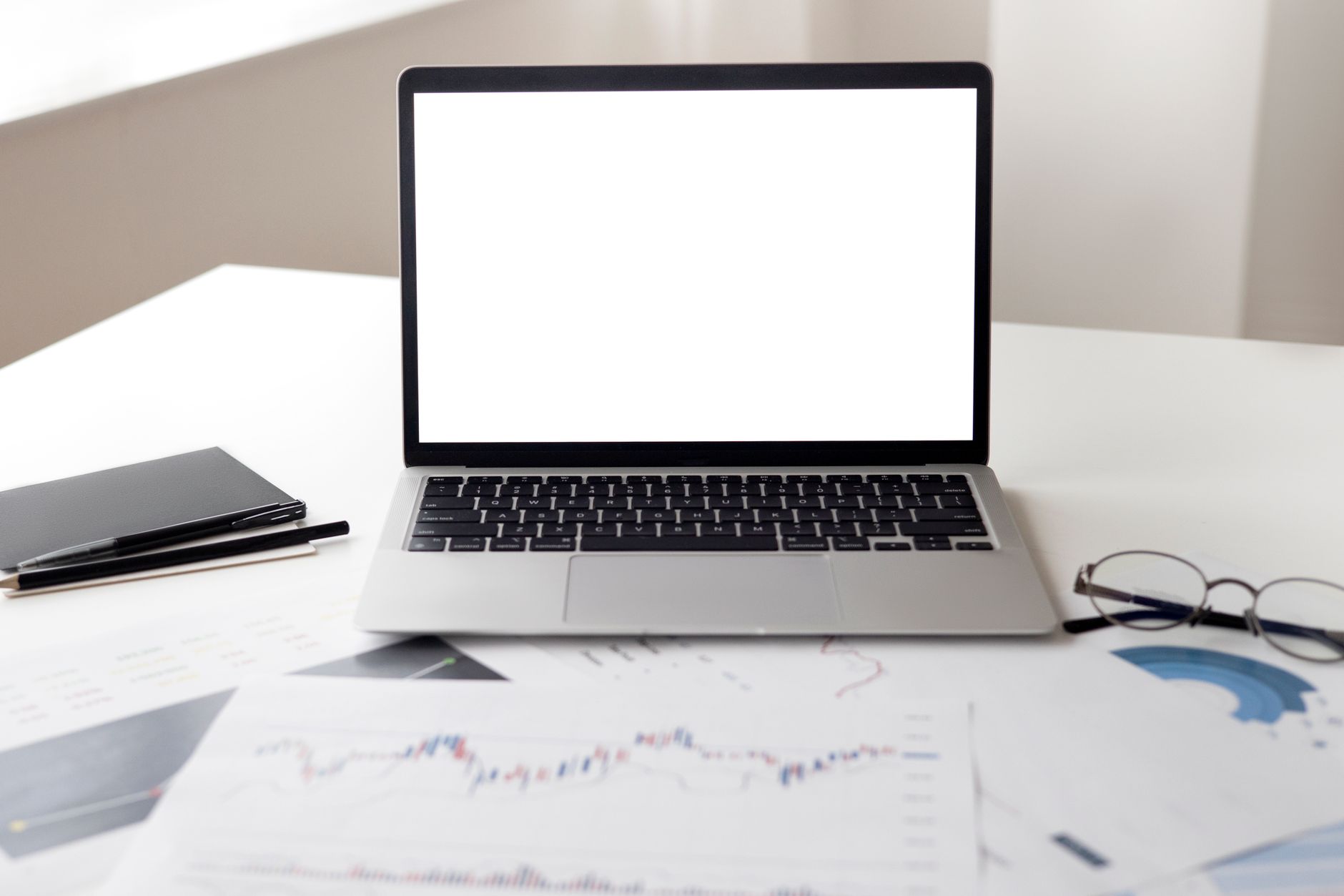 Laptop with financial documents representing digital marketing analytics and strategy